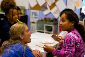 REALM co-founder Jessica Slayback talks with a student.