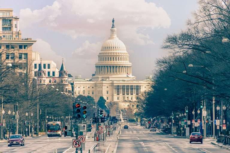 US Capitol building viewed from a road.