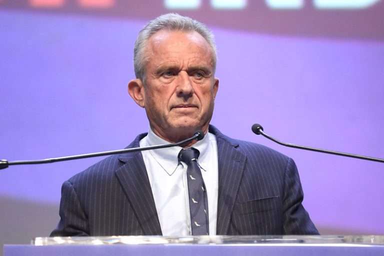 RFK Jr. delivering a speech at a podium.