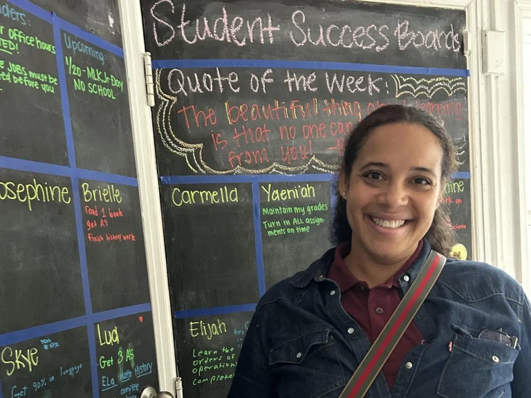 Shiren Rattigan in front of a blackboard.