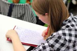 Girl writing at a desk.