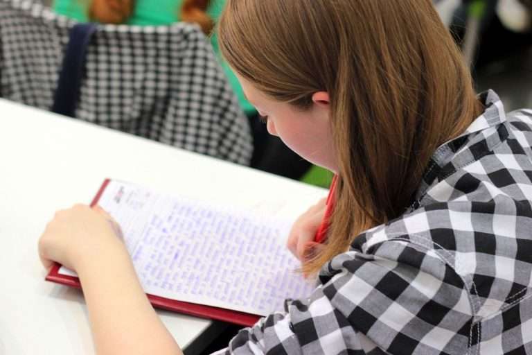 Girl writing at a desk.