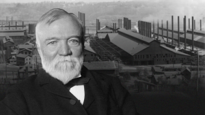 Black-and-white photo of Andrew Carnegie with a factory in the background.