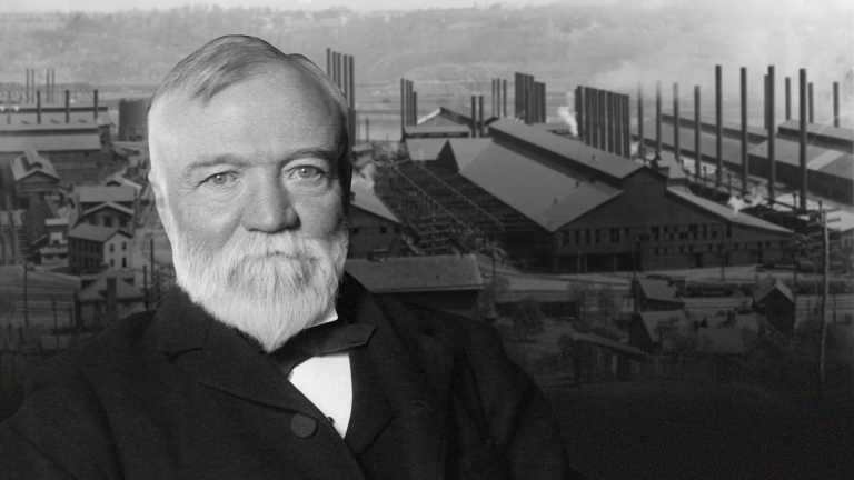 Black-and-white photo of Andrew Carnegie with a factory in the background.