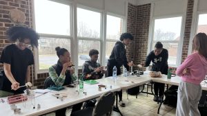 Students standing around desks.