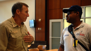 USAID worker talking with a soldier.