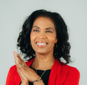 Kym Kent is a Black woman, wearing a red shirt