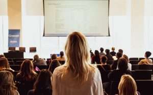 Woman standing in a meeting.