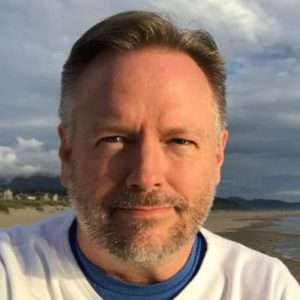 portrait of Jon Gabriel on a beach