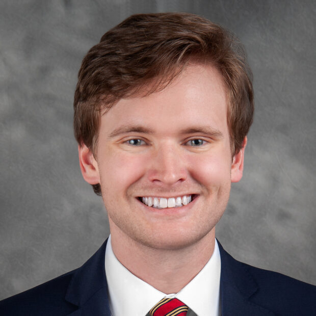 portrait photo of J. Thomas Perdue wearing a suit
